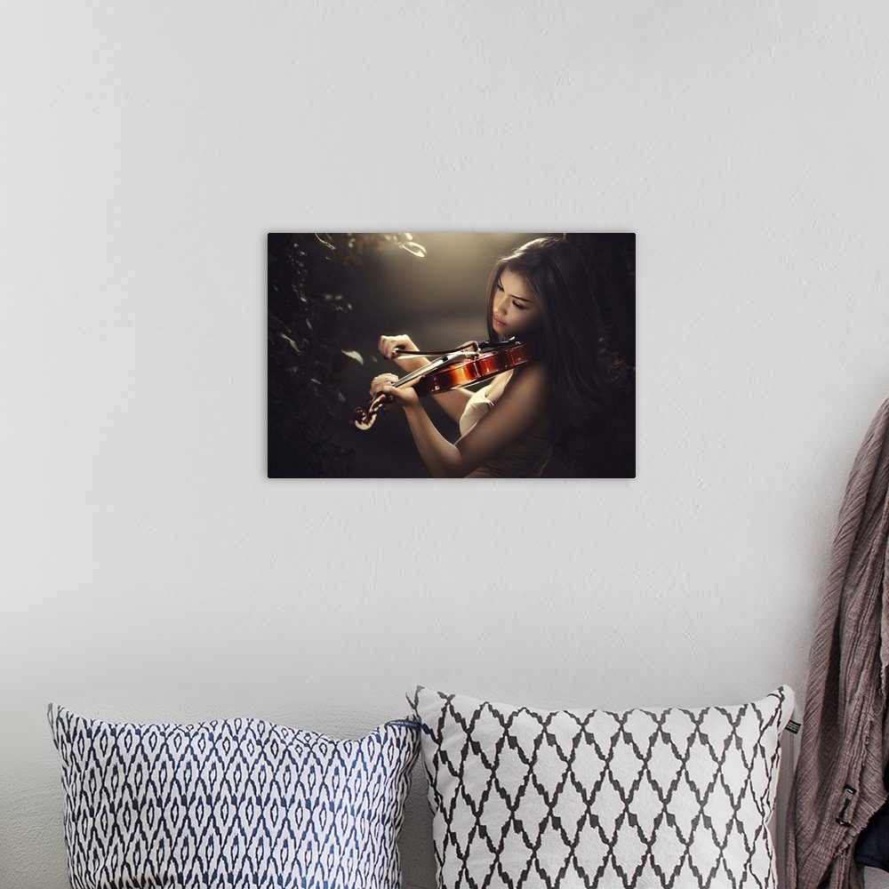 A bohemian room featuring A beautiful woman with long dark hair playing a violin.