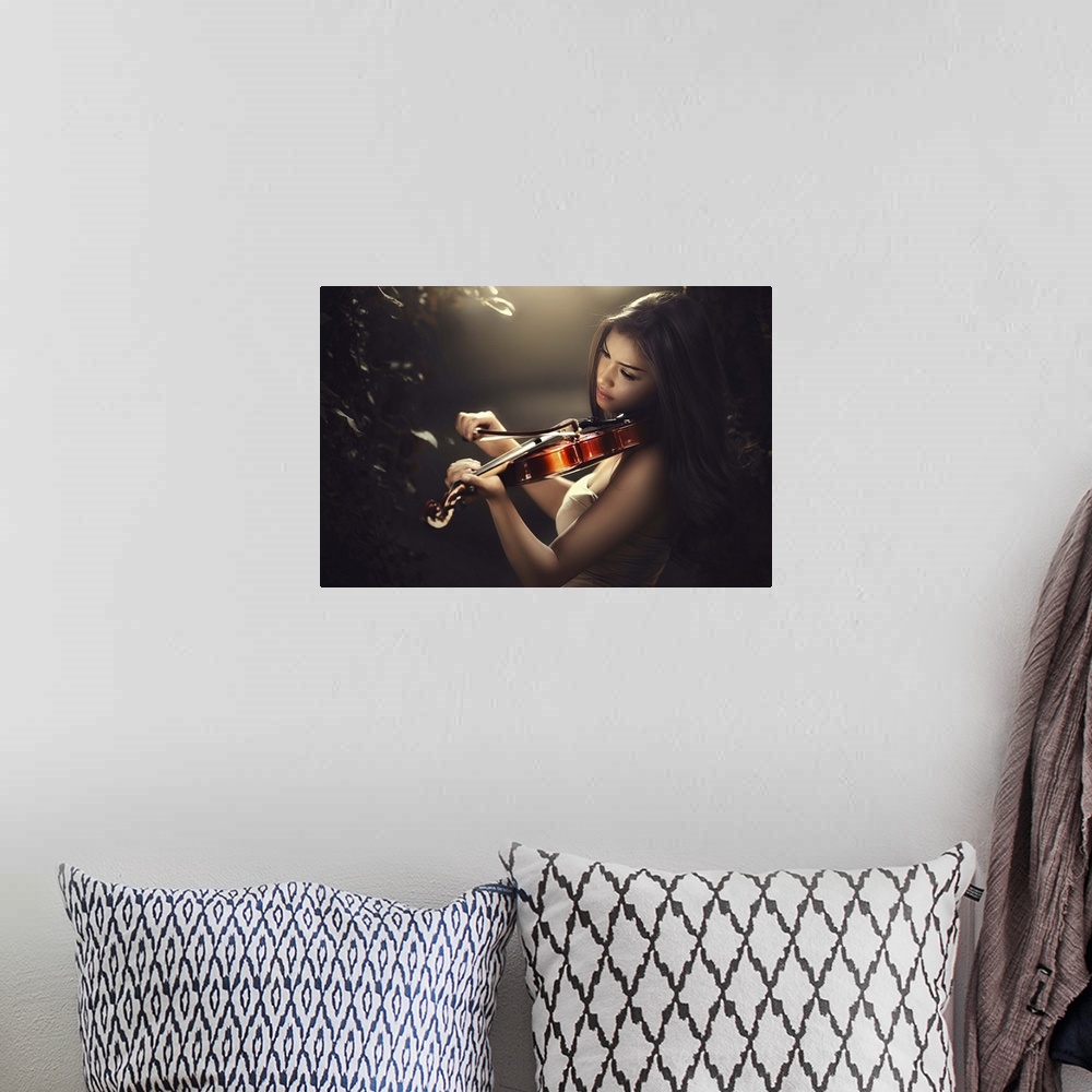 A bohemian room featuring A beautiful woman with long dark hair playing a violin.