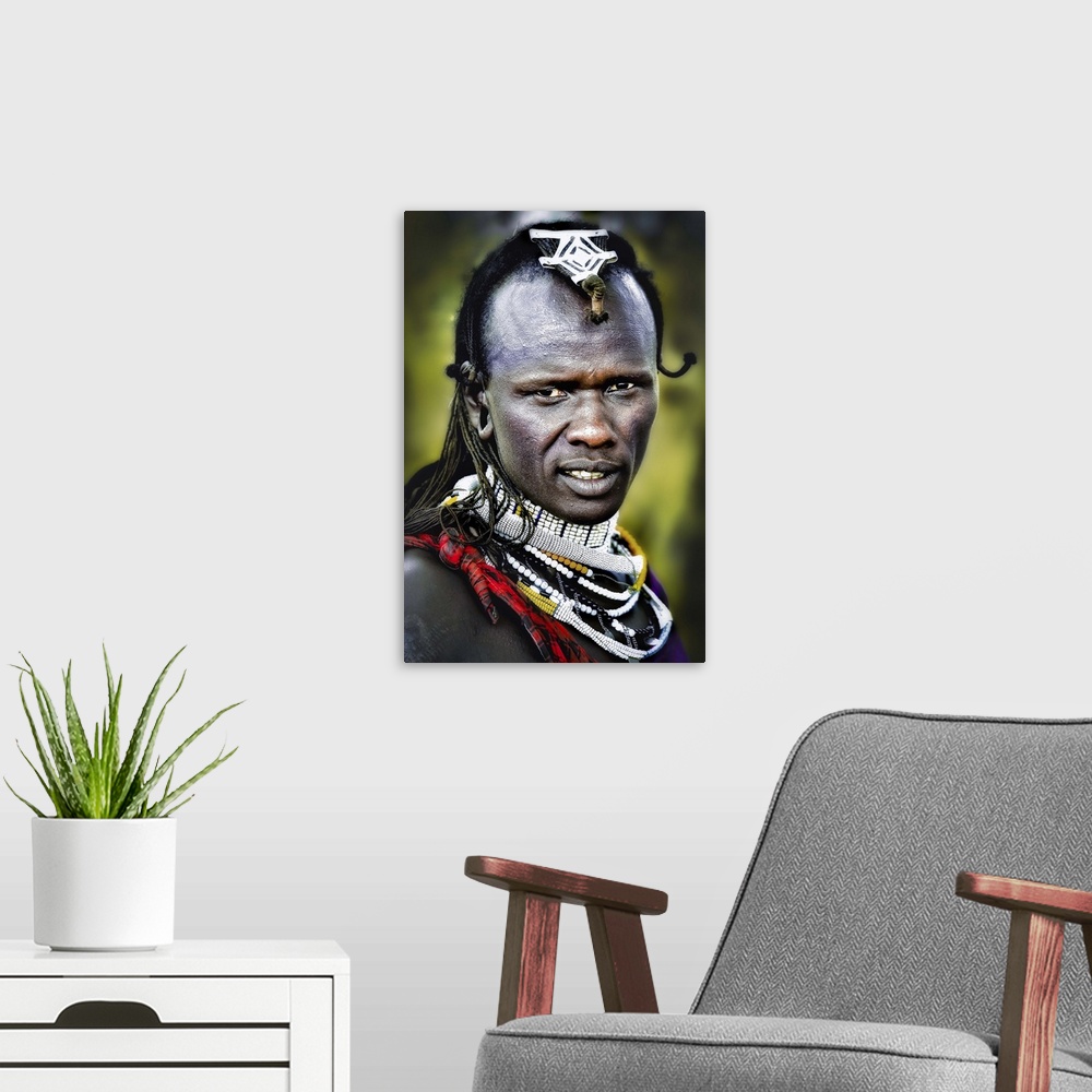 A modern room featuring A man wearing decorative jewelry and headpieces in the Masai Mara area of Tanzania.