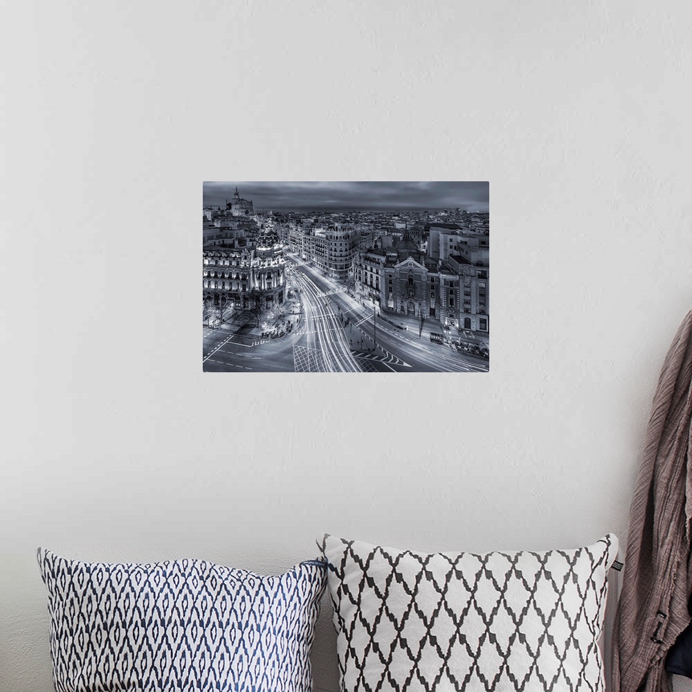 A bohemian room featuring A photograph of Madrid with light trails covering the roads, Spain.