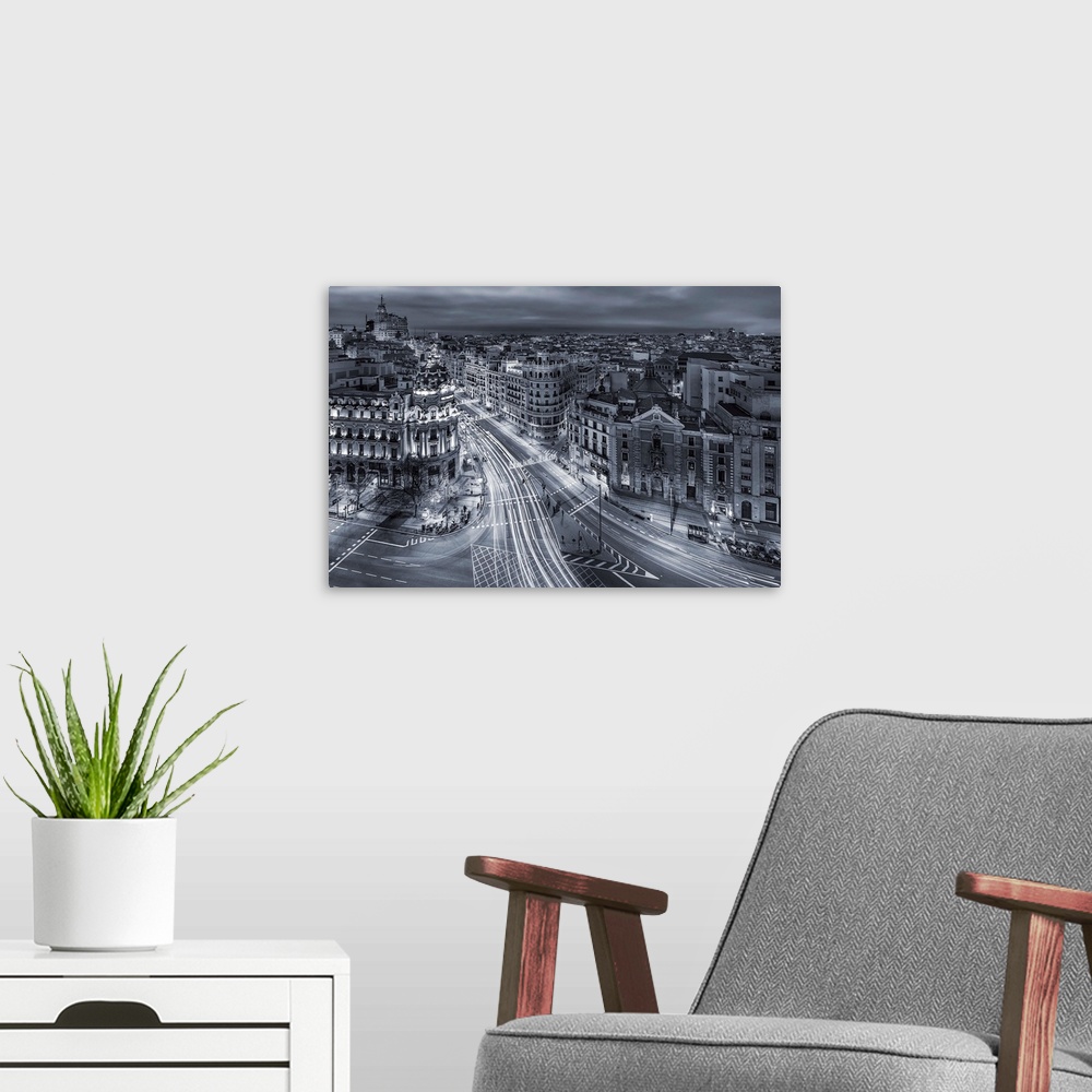 A modern room featuring A photograph of Madrid with light trails covering the roads, Spain.