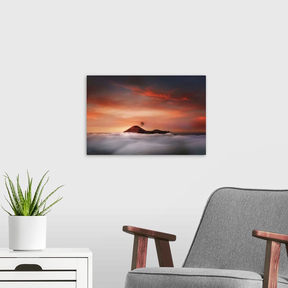 A modern room featuring The peaks of Mahameru in Indonesia at sunset, visible over the clouds.