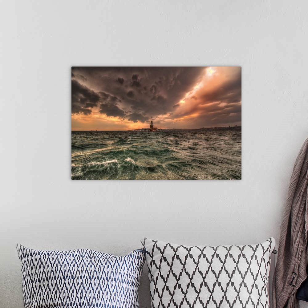 A bohemian room featuring Lighthouse connecting the sea and the clouds above at sunset.