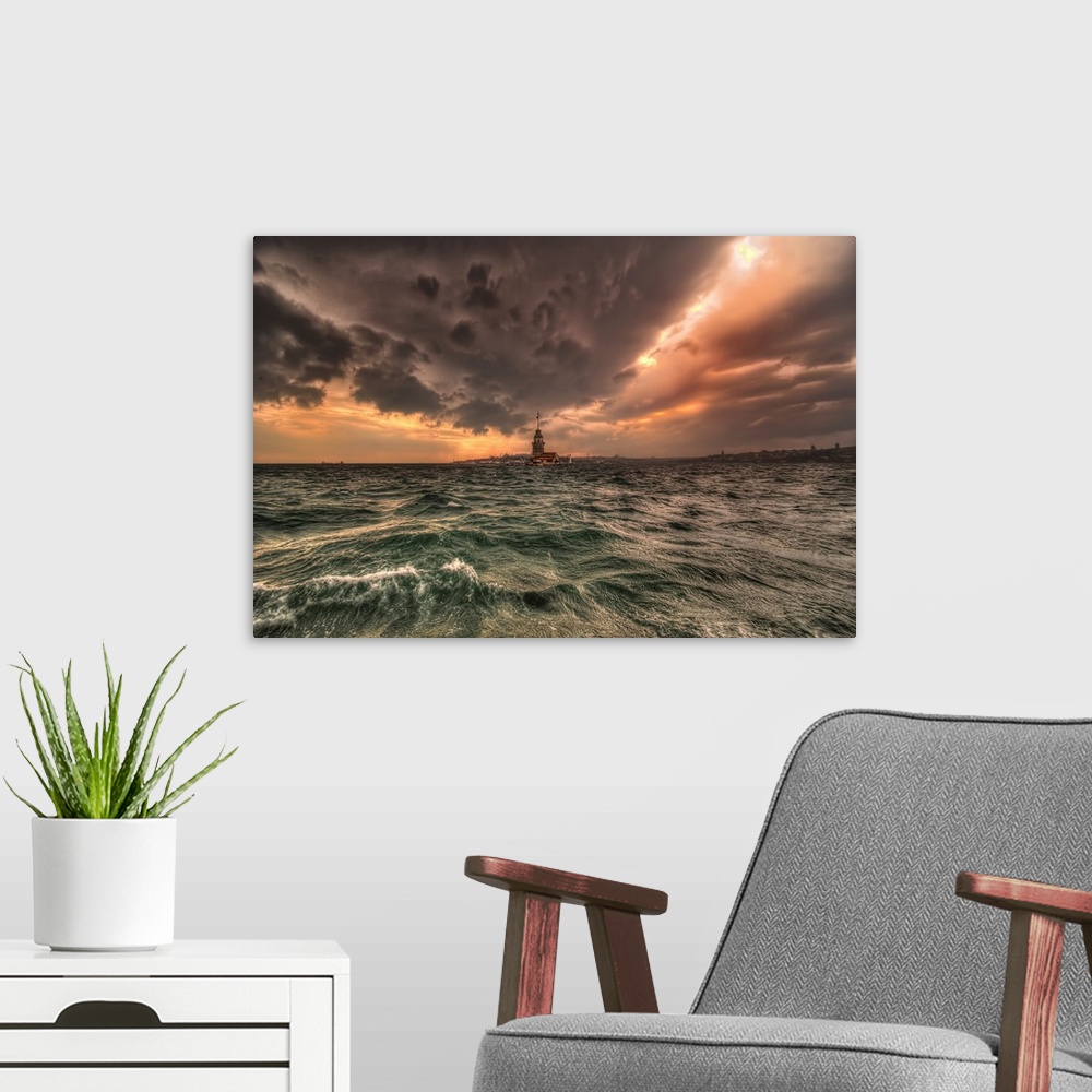 A modern room featuring Lighthouse connecting the sea and the clouds above at sunset.