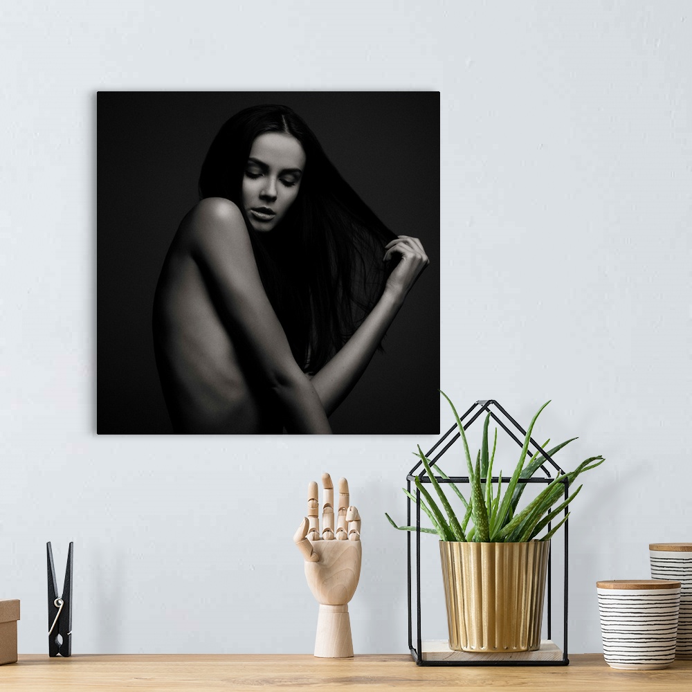 A bohemian room featuring Nude portrait of a beautiful woman with long dark hair.