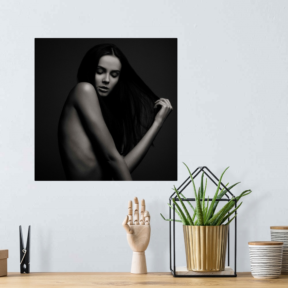 A bohemian room featuring Nude portrait of a beautiful woman with long dark hair.