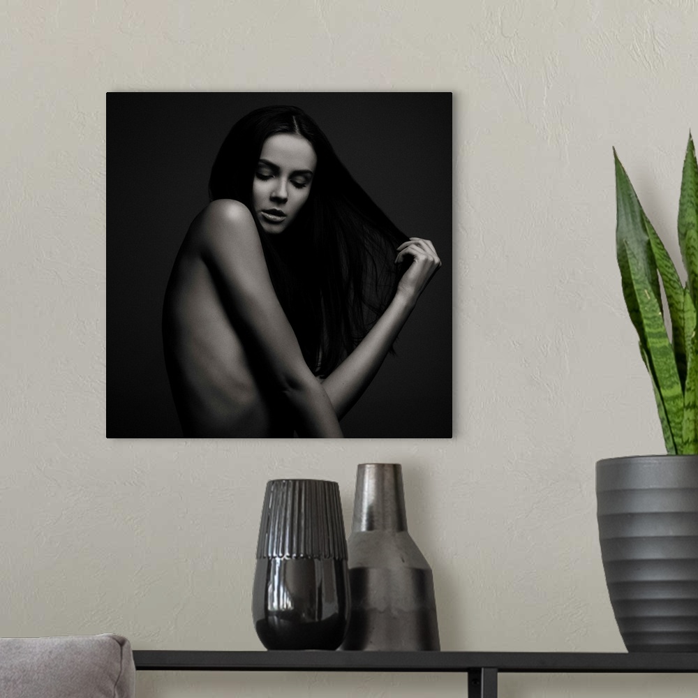 A modern room featuring Nude portrait of a beautiful woman with long dark hair.