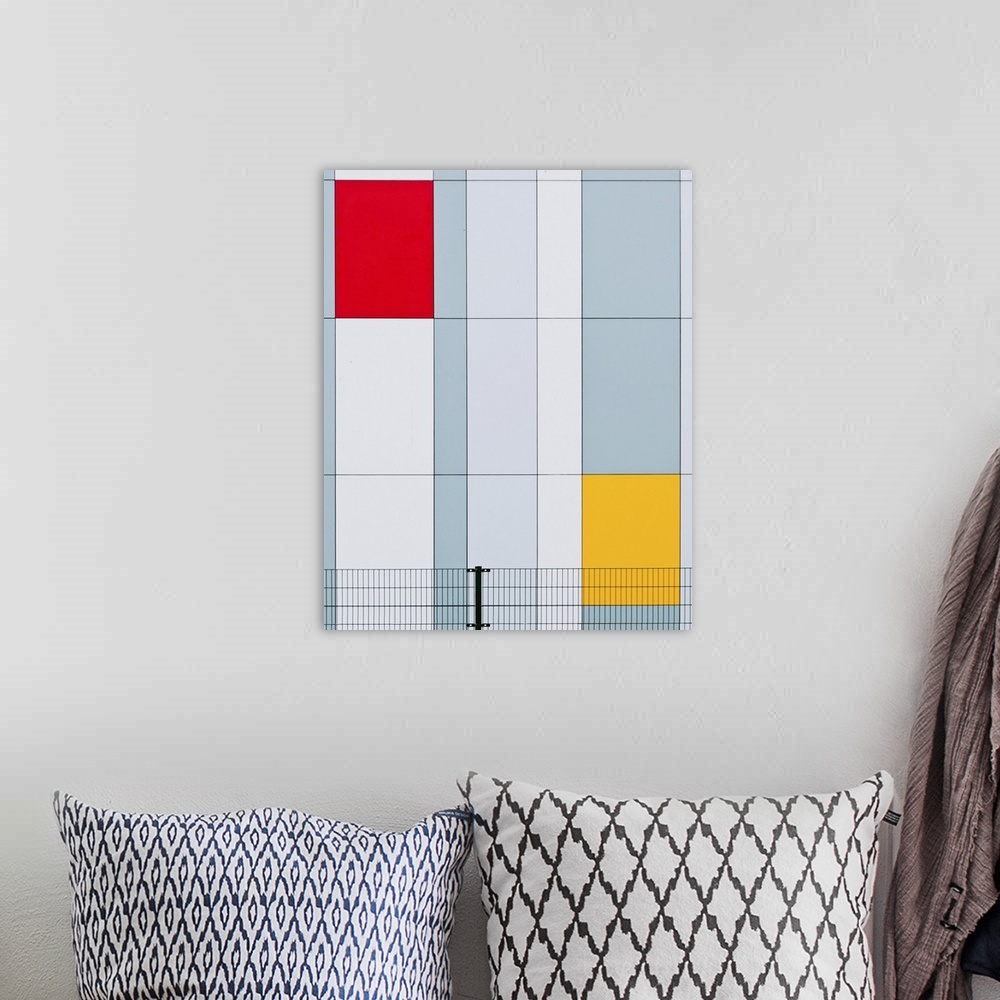 A bohemian room featuring The facade of a building with red and yellow panels resembling a Mondrian painting.