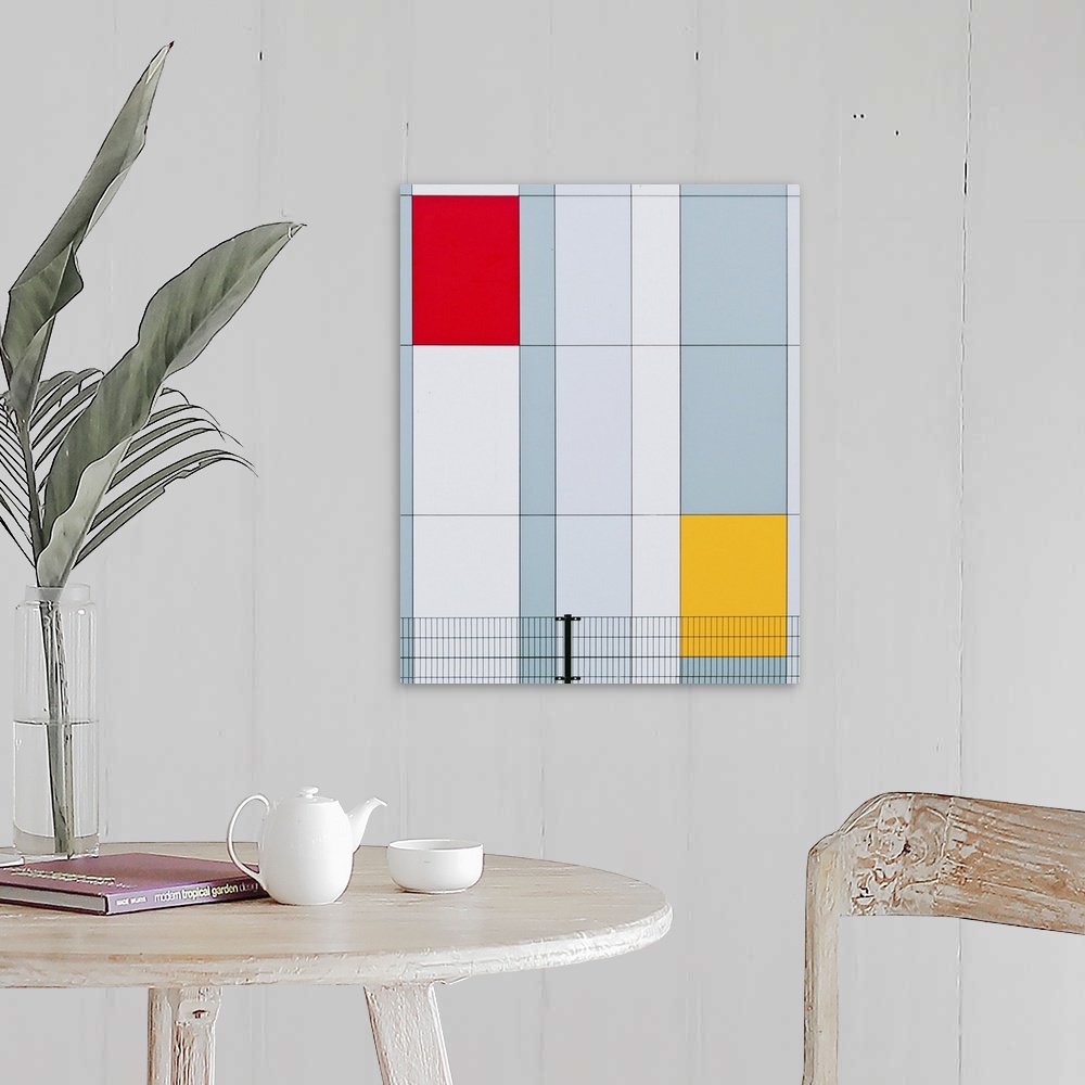A farmhouse room featuring The facade of a building with red and yellow panels resembling a Mondrian painting.