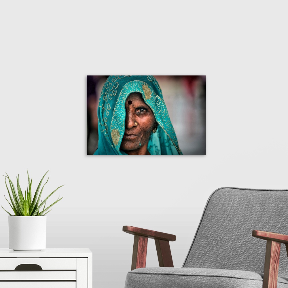 A modern room featuring Portrait of an elderly woman wearing a turquoise embroidered veil.
