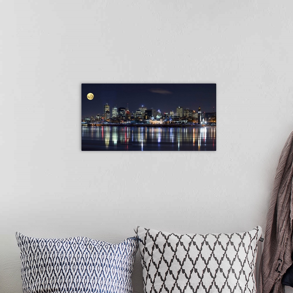 A bohemian room featuring Colorful city lights of the Montreal skyline reflected in the water at night.