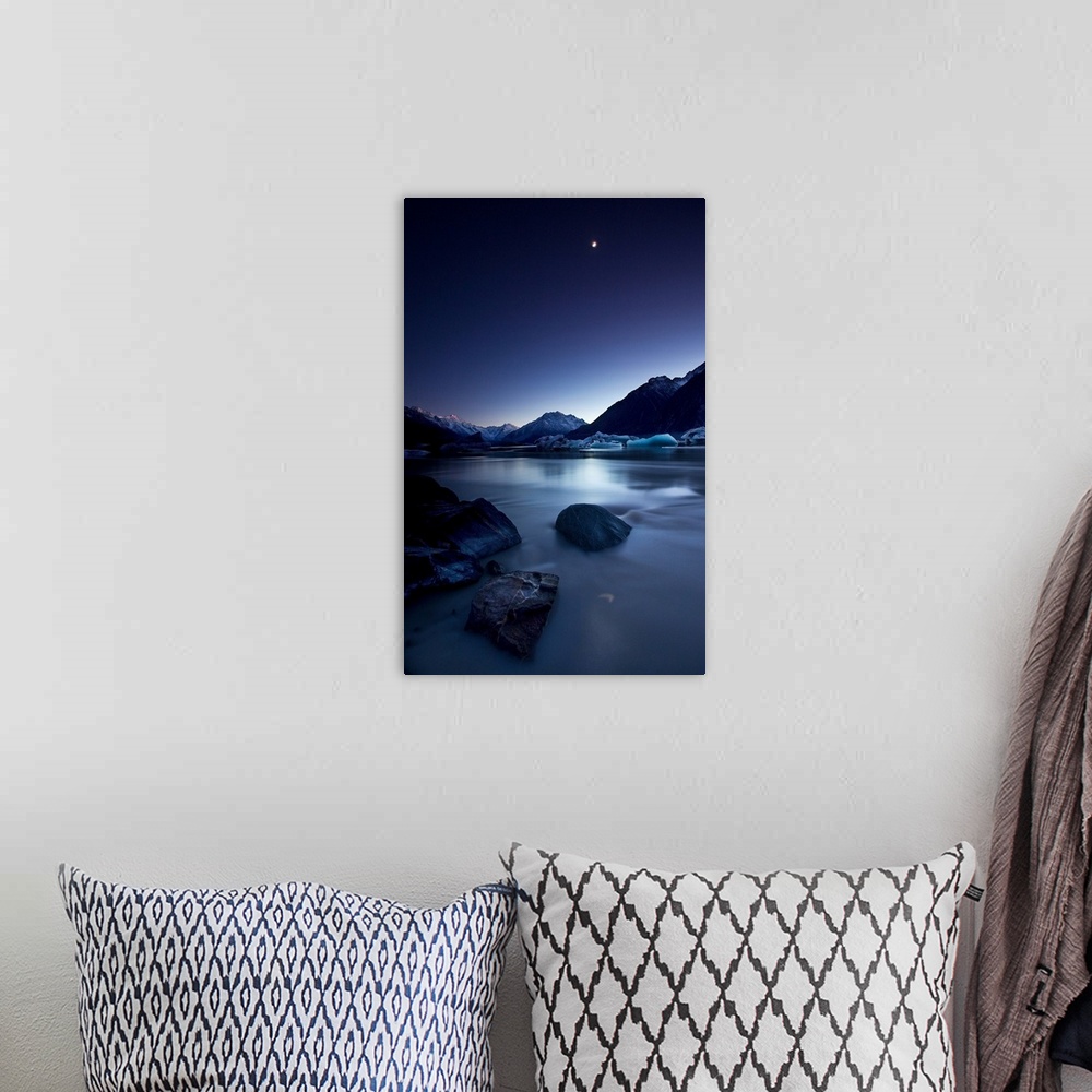 A bohemian room featuring View of the moon over a river and snowy mountains in the evening, New Zealand.