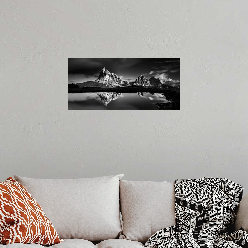A bohemian room featuring Black and white panoramic landscape photograph of the Dolomites, Italy with reflections on the lake.