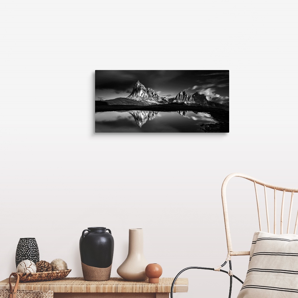 A farmhouse room featuring Black and white panoramic landscape photograph of the Dolomites, Italy with reflections on the lake.