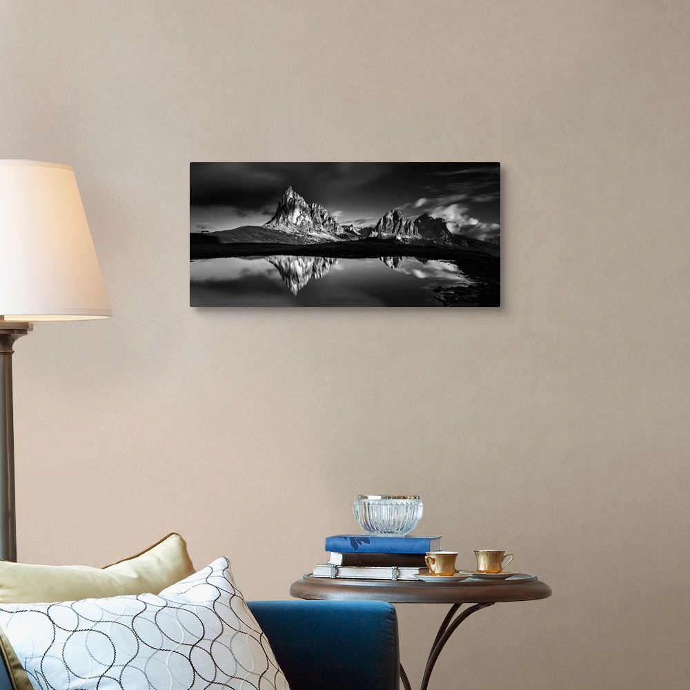 A traditional room featuring Black and white panoramic landscape photograph of the Dolomites, Italy with reflections on the lake.
