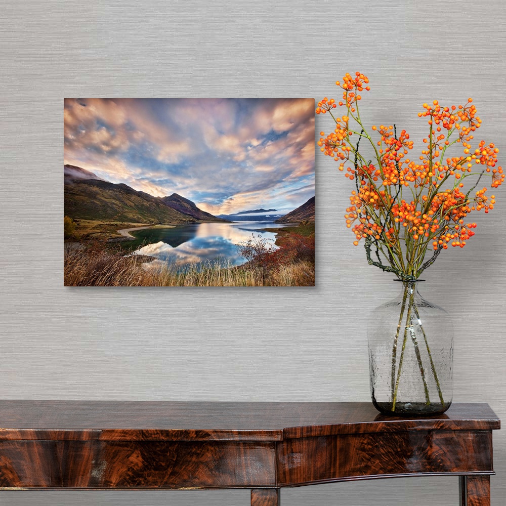 A traditional room featuring Dramatic clouds hang over a mountain lake scene.