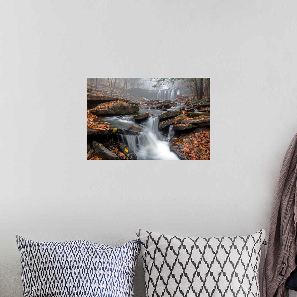 A bohemian room featuring A waterfall and stream with a rocky bed and fallen leaves in a misty forest in Ricketts Glen, Pen...