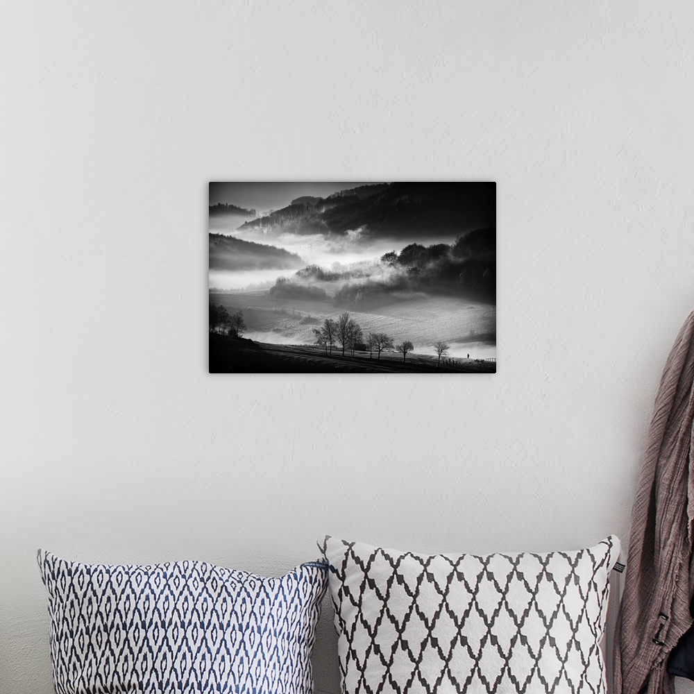 A bohemian room featuring Black and white image of a foggy valley in the morning.