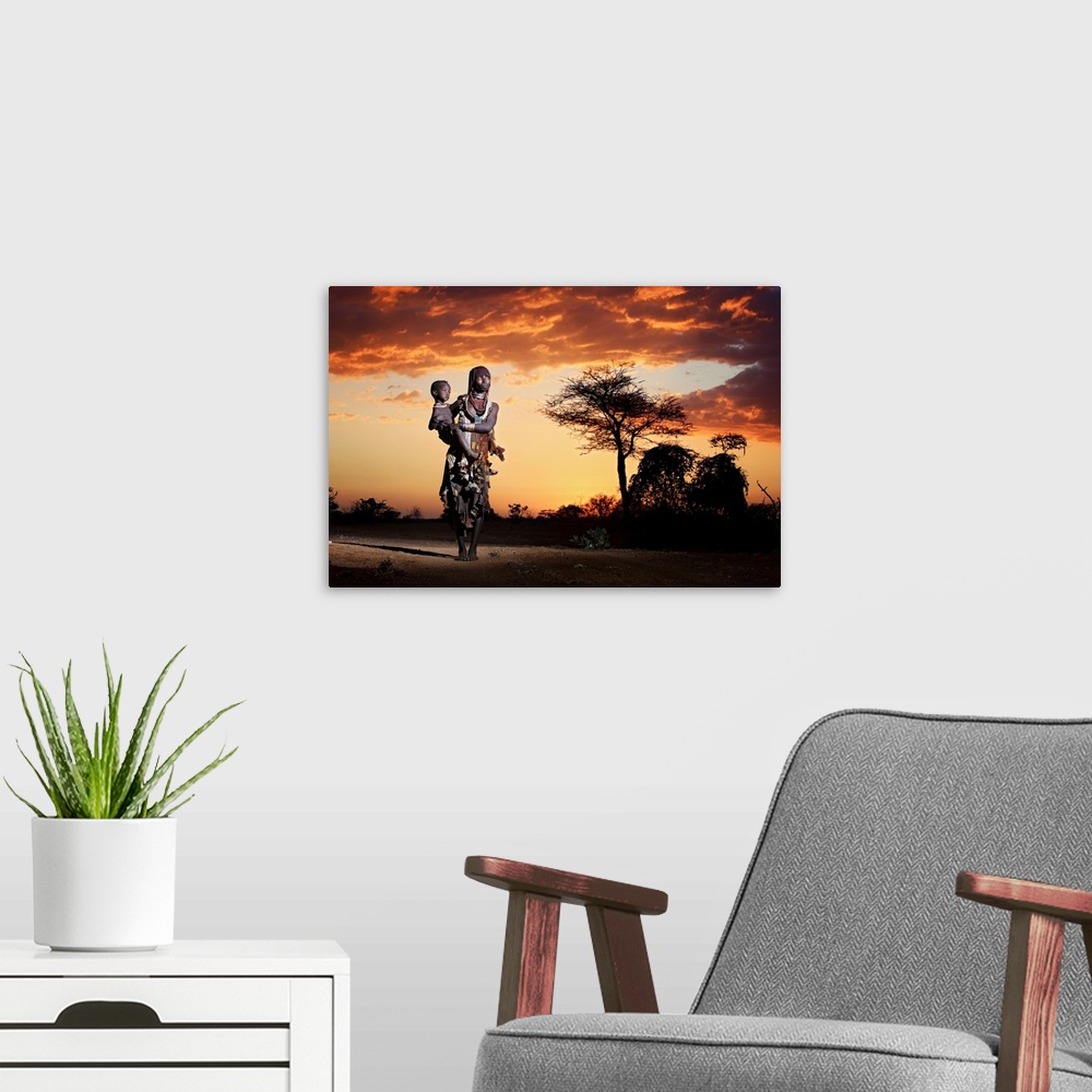 A modern room featuring A portrait of a tribes-woman holding her child underneath a sunset sky.