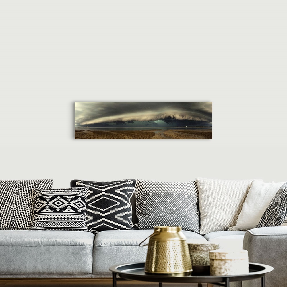 A bohemian room featuring Panoramic image of a beach with a thick wall of stormclouds approaching.