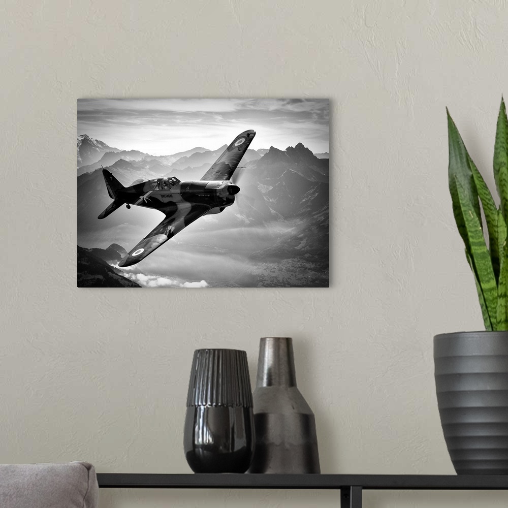 A modern room featuring Black and white image of a vintage airplane flying over the Swiss Alps.