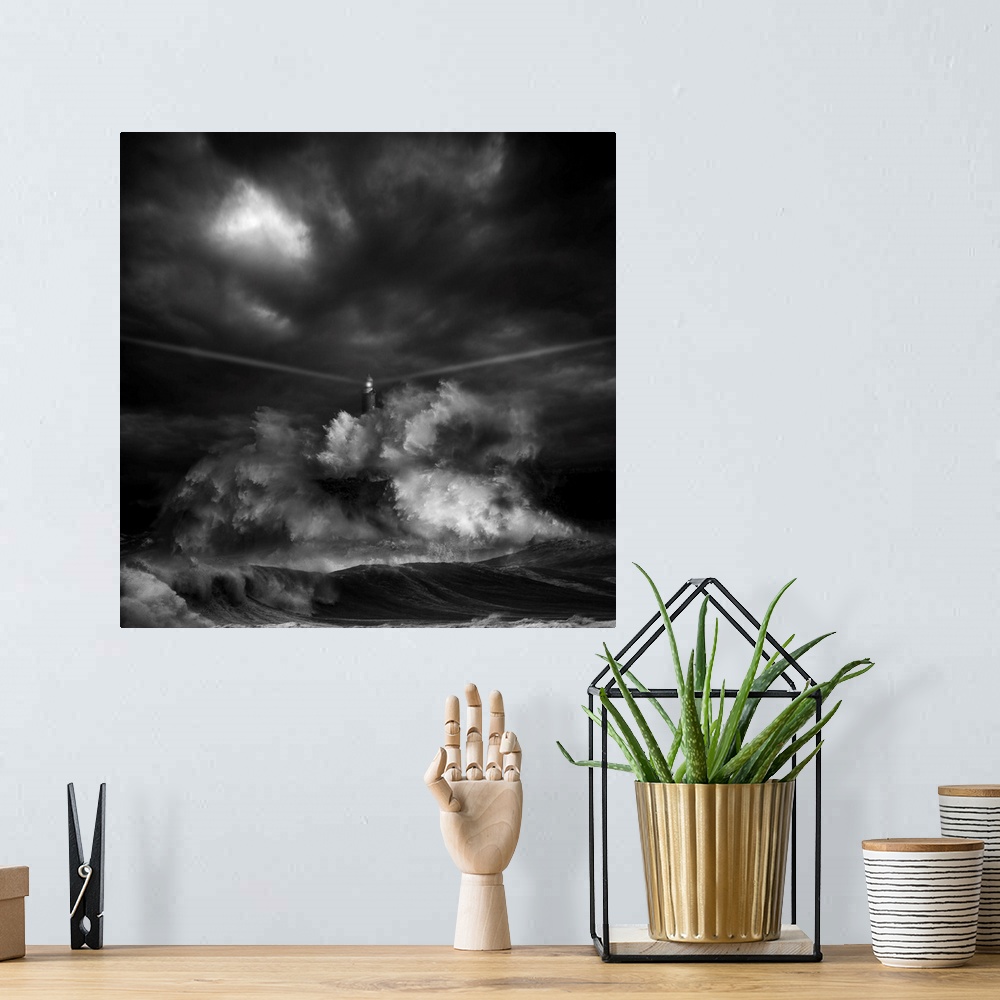 A bohemian room featuring A black and white photograph of a lighthouse with light beaming from it's sides while a massive w...