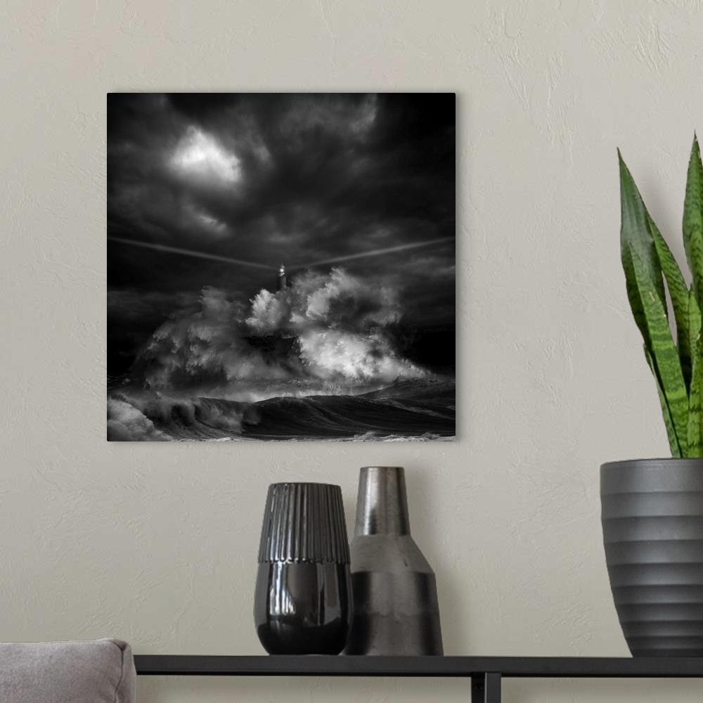 A modern room featuring A black and white photograph of a lighthouse with light beaming from it's sides while a massive w...