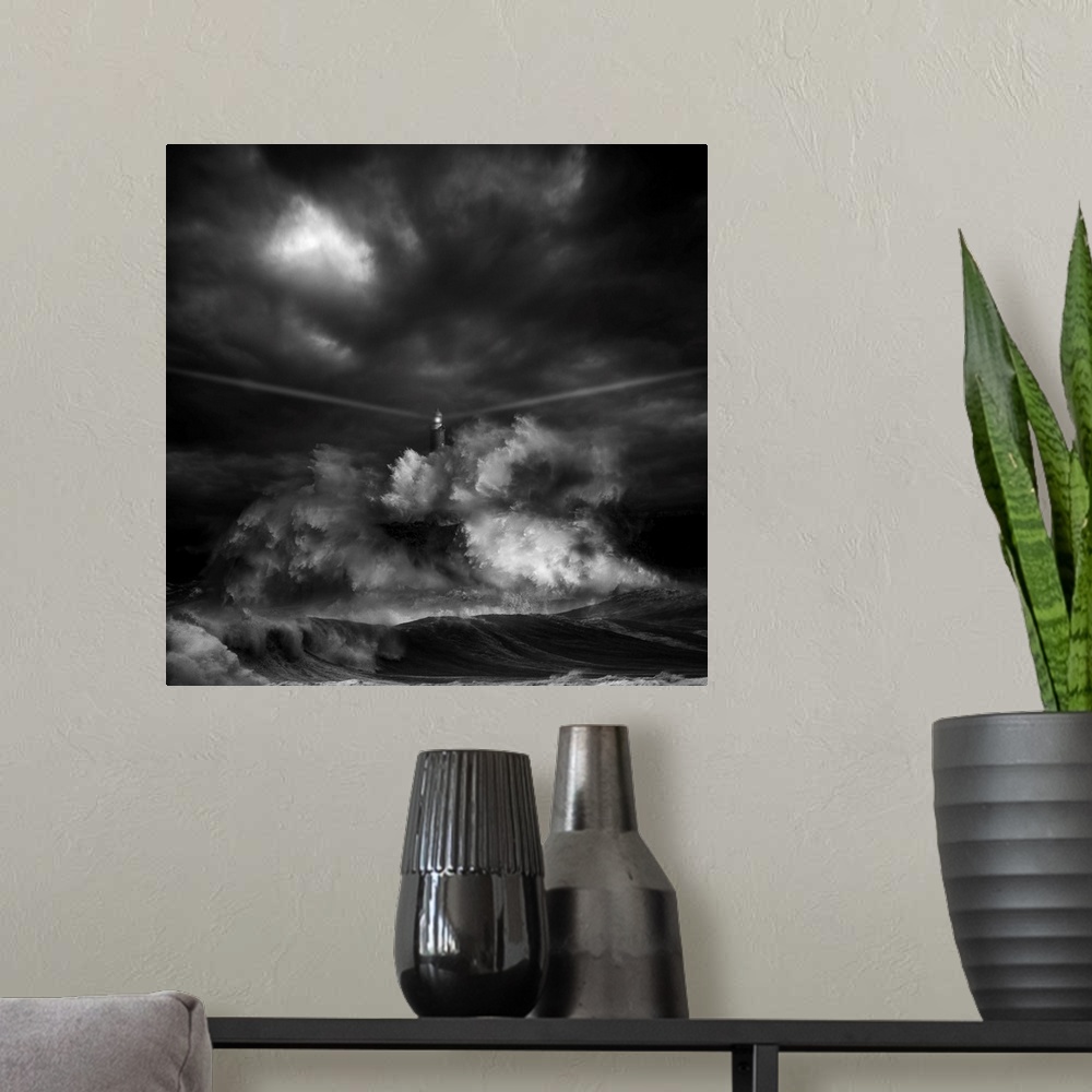 A modern room featuring A black and white photograph of a lighthouse with light beaming from it's sides while a massive w...