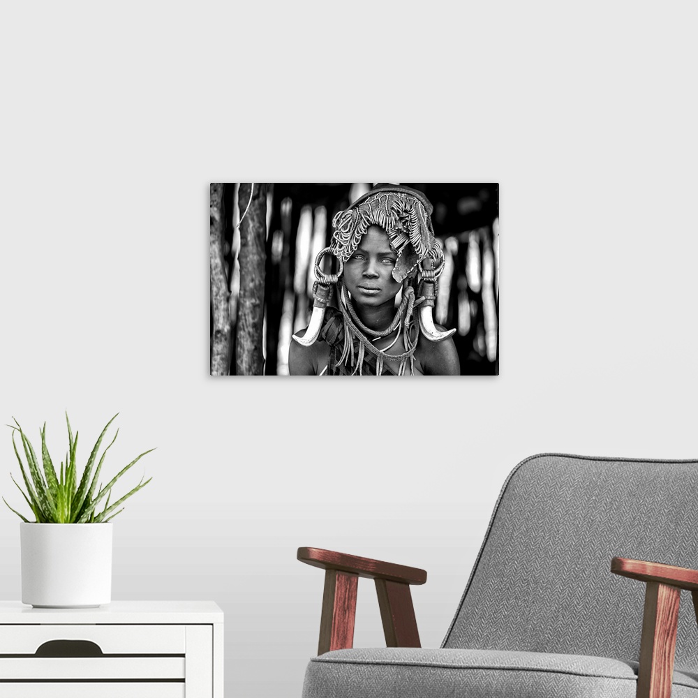 A modern room featuring A portrait of a tribeswoman with a unique headdress.