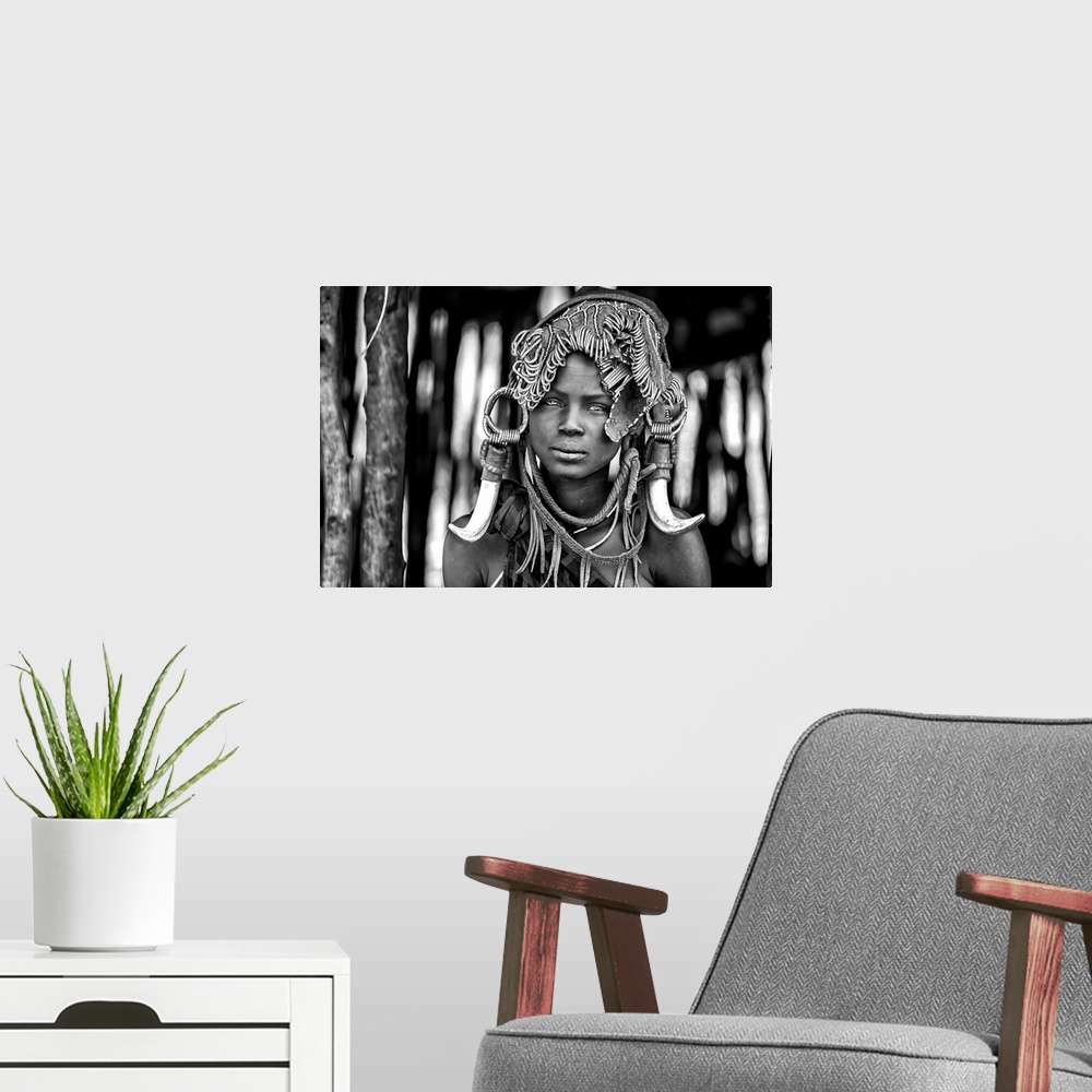 A modern room featuring A portrait of a tribeswoman with a unique headdress.
