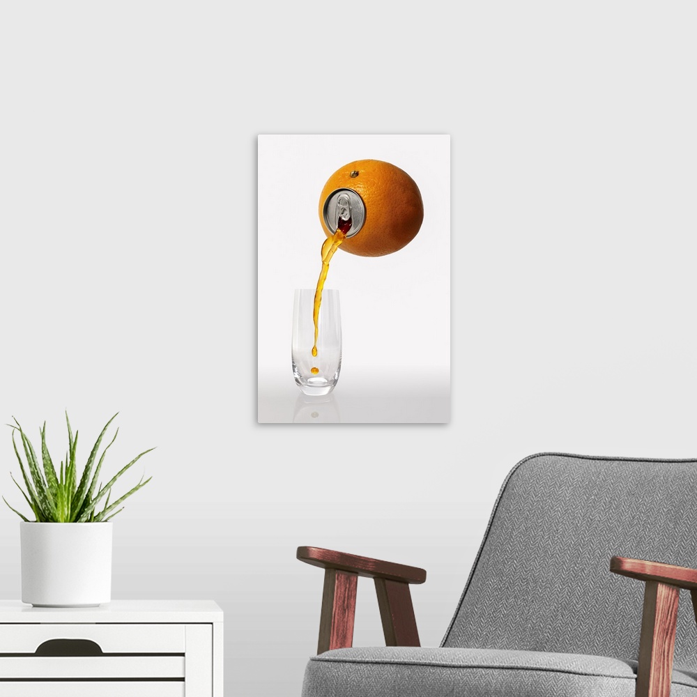 A modern room featuring Juice from an orange with a pop-top being poured into a glass.