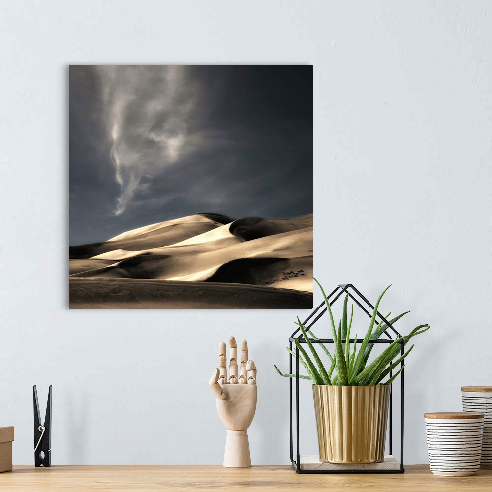 A bohemian room featuring Desert sand dunes casting deep shadows under a darkening sky, Colorado.
