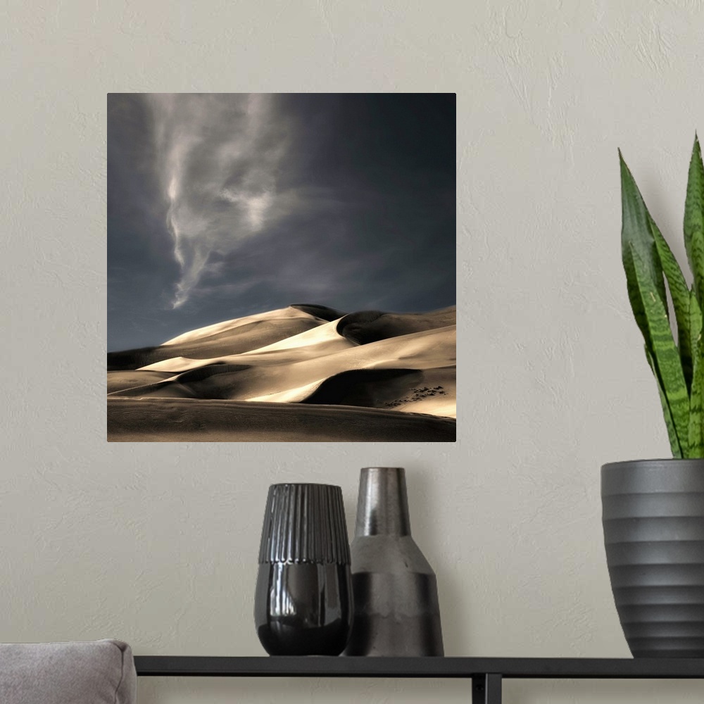 A modern room featuring Desert sand dunes casting deep shadows under a darkening sky, Colorado.