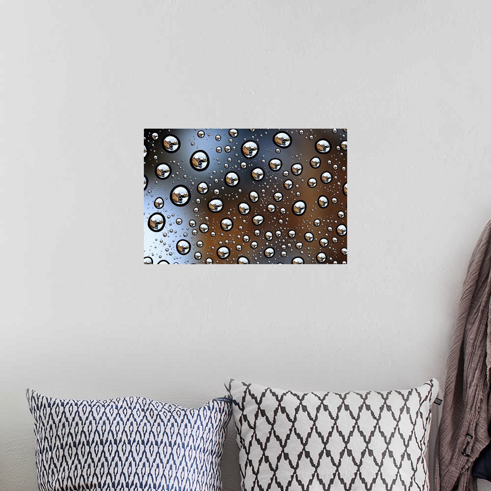 A bohemian room featuring Image of a house reflected several times in tons of water droplets.