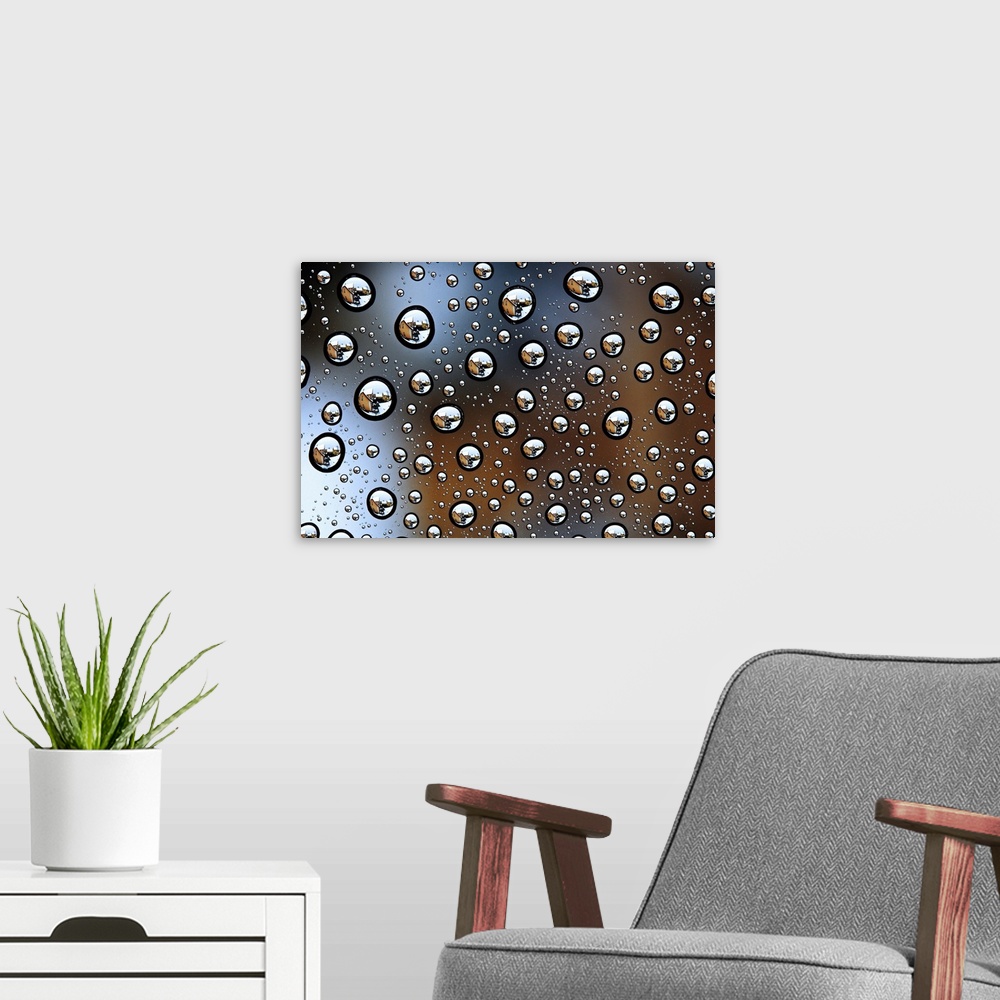 A modern room featuring Image of a house reflected several times in tons of water droplets.