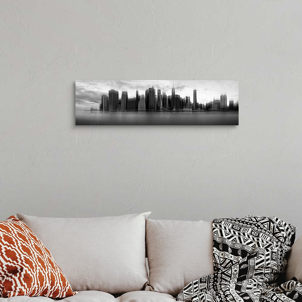 A bohemian room featuring Black and white panoramic view of the skyscrapers of New York City on a cloudy day.