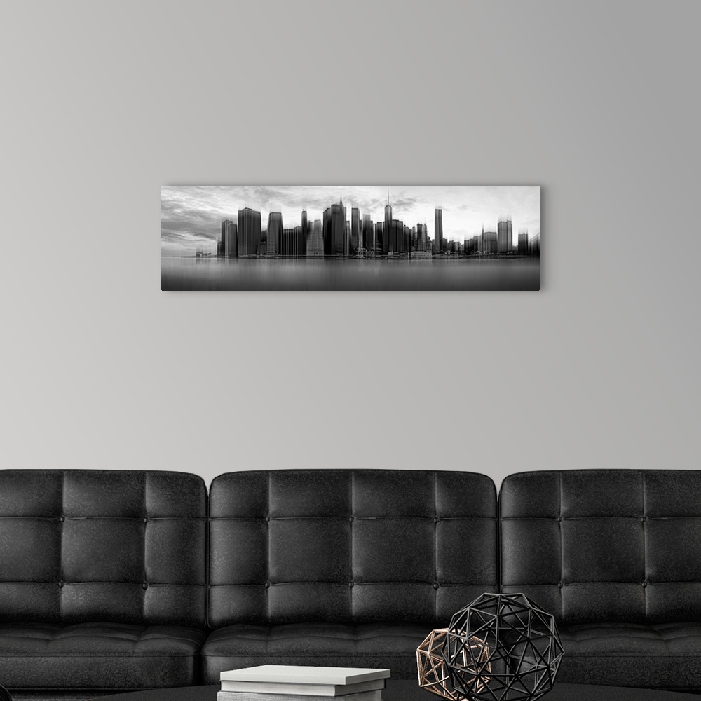 A modern room featuring Black and white panoramic view of the skyscrapers of New York City on a cloudy day.