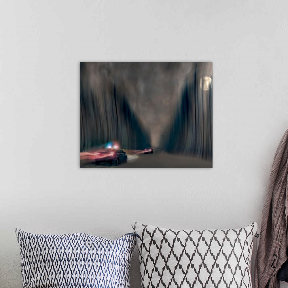 A bohemian room featuring Blurred motion image of a police car chasing a speeding vehicle.