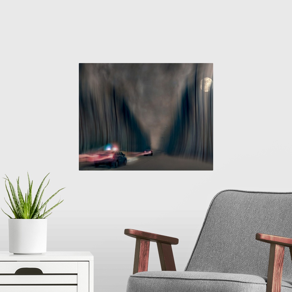 A modern room featuring Blurred motion image of a police car chasing a speeding vehicle.