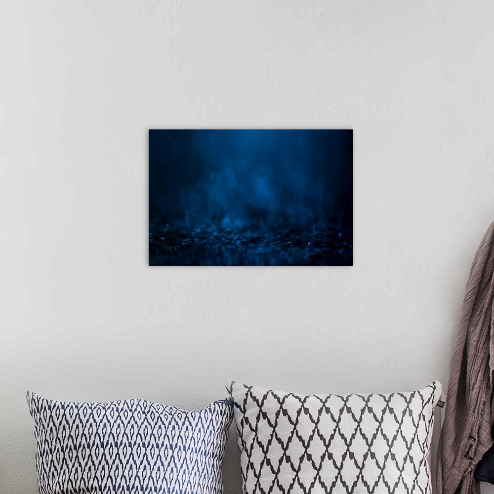 A bohemian room featuring Abstract digital waterscape with dark blue and black hues.
