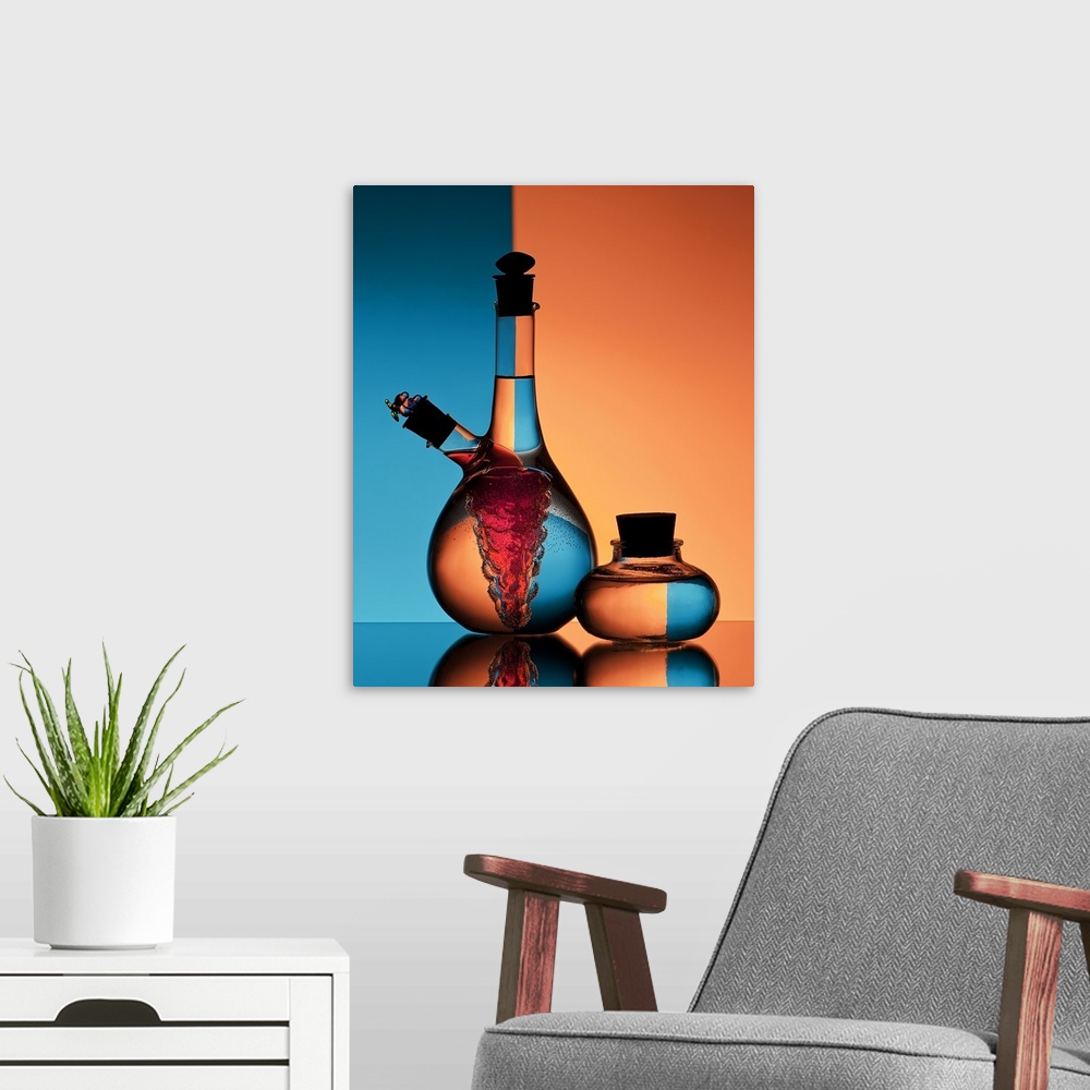 A modern room featuring Two glass jars of oil and vinegar reflecting backwards images of the orange and blue walls in the...