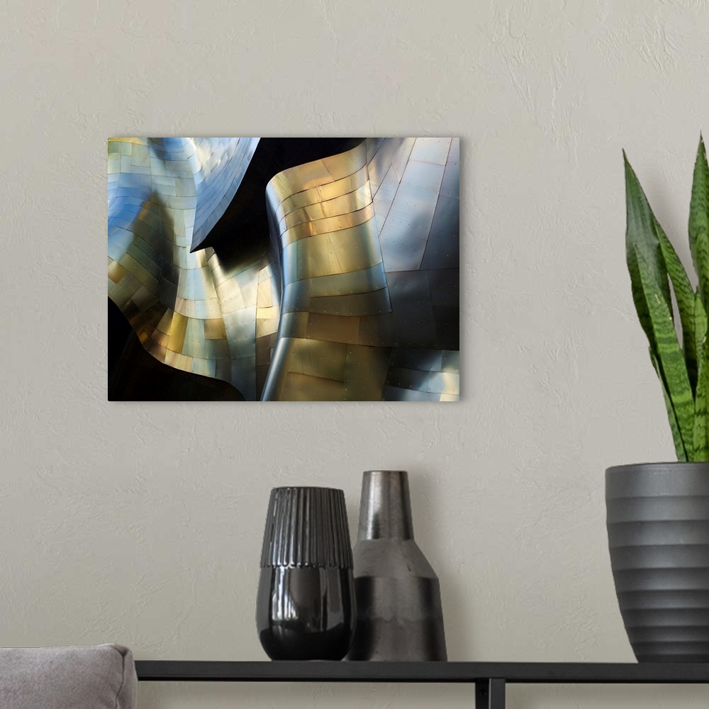 A modern room featuring A photograph of an abstract view of a curved metal building facade.