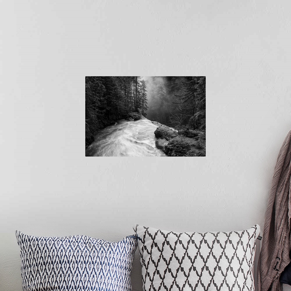 A bohemian room featuring Nooksack falls flowing over jagged rocks in a forest in Washington.