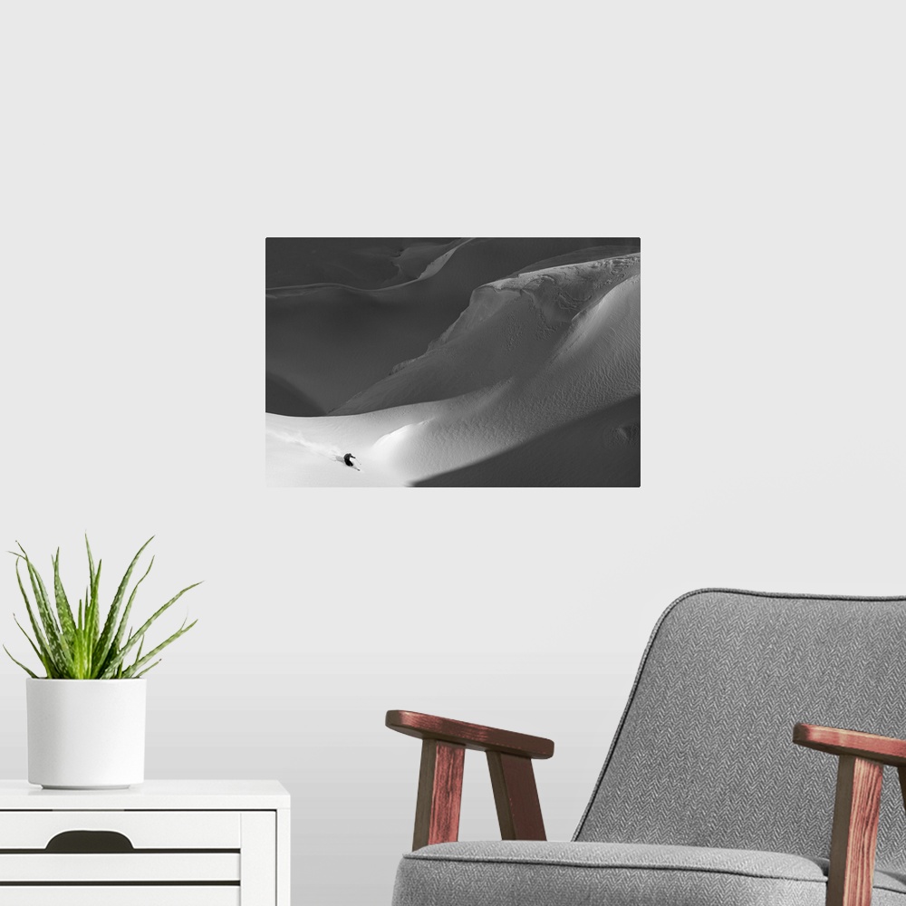 A modern room featuring A skier on the side of a treacherous snowy mountain.