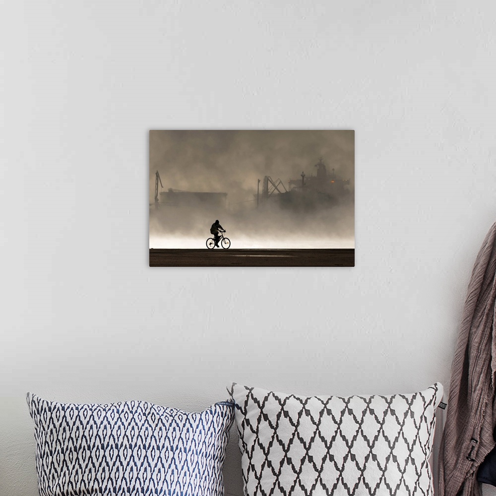 A bohemian room featuring Silhouette of a cyclist in front of smoke coming from the harbor.