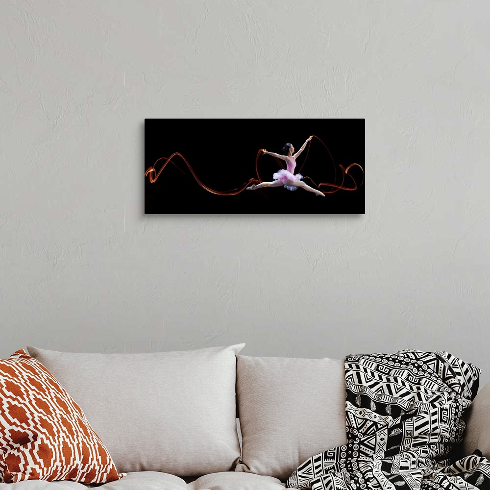 A bohemian room featuring A ballerina leaping, with light trails left in the air from her movements.