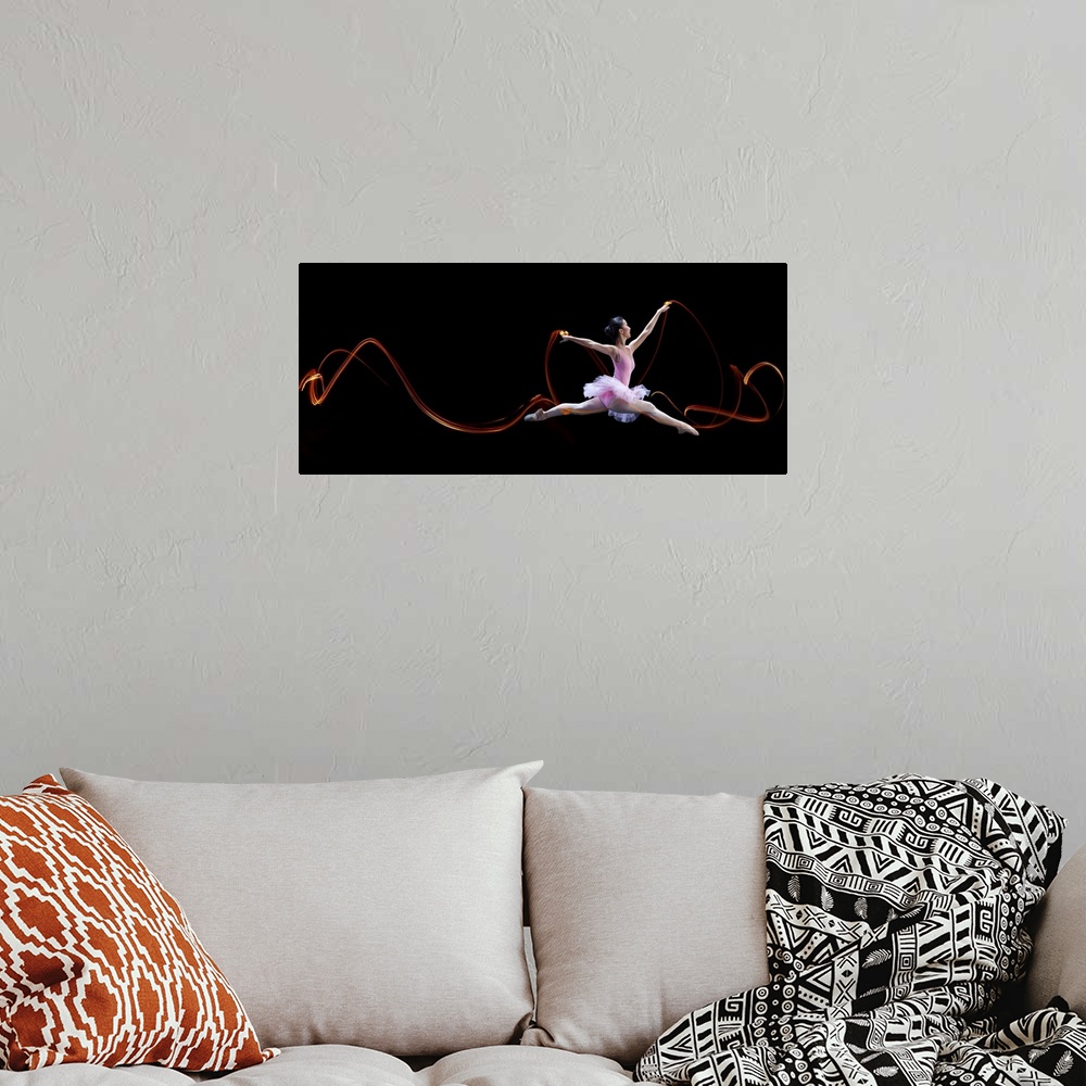A bohemian room featuring A ballerina leaping, with light trails left in the air from her movements.