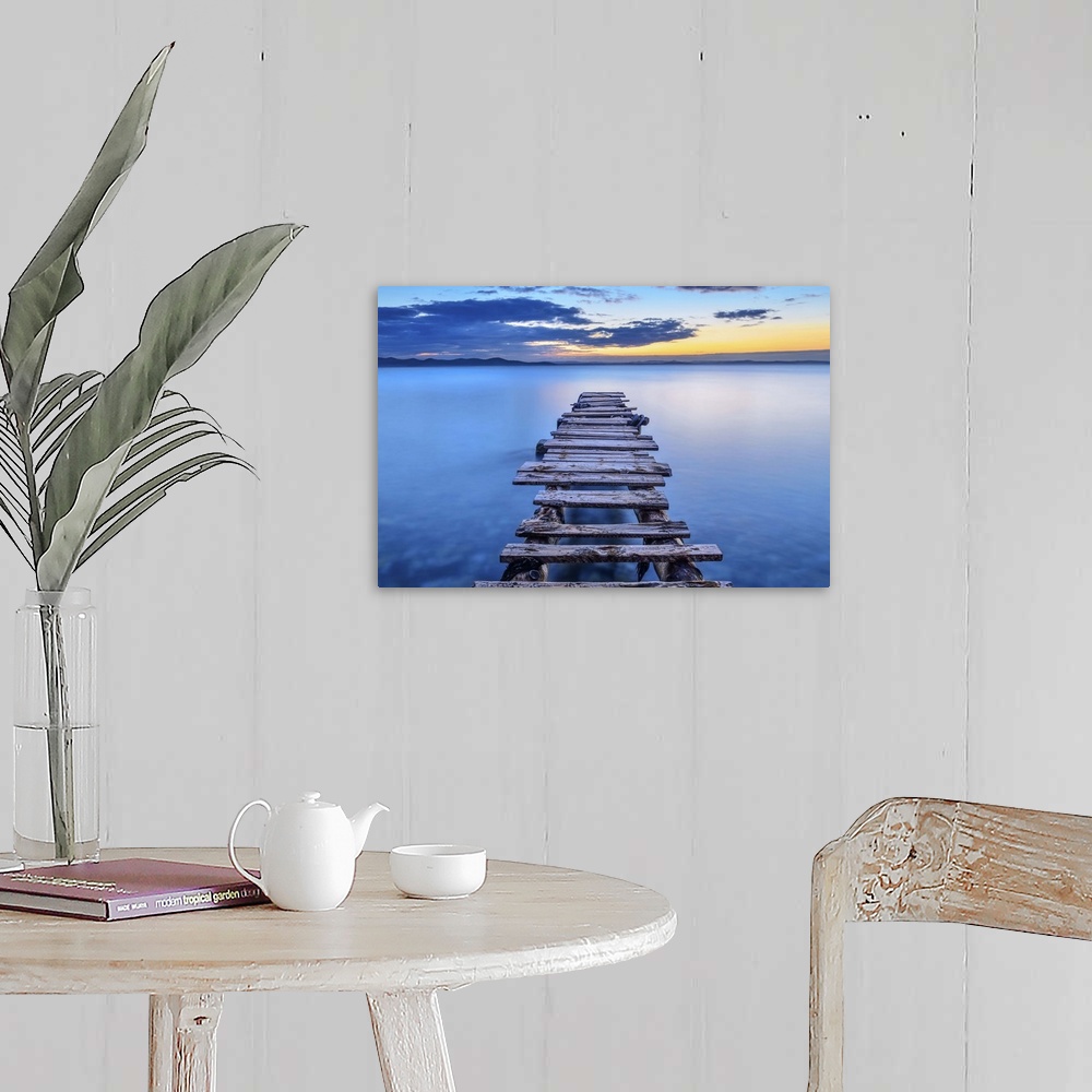 A farmhouse room featuring A decrepit pier jetting out over smooth blue water in Croatia.