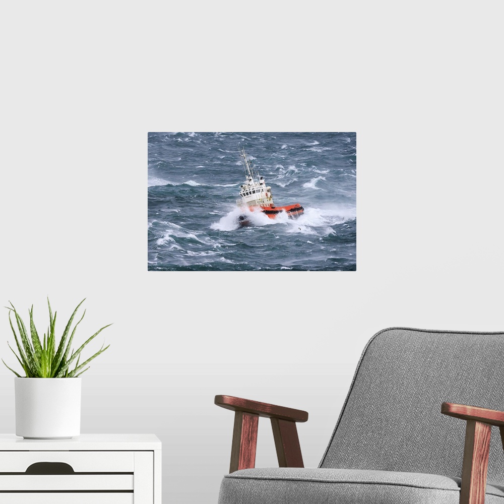 A modern room featuring A tugboat navigates the rough ocean waves off the Icelandic coast.