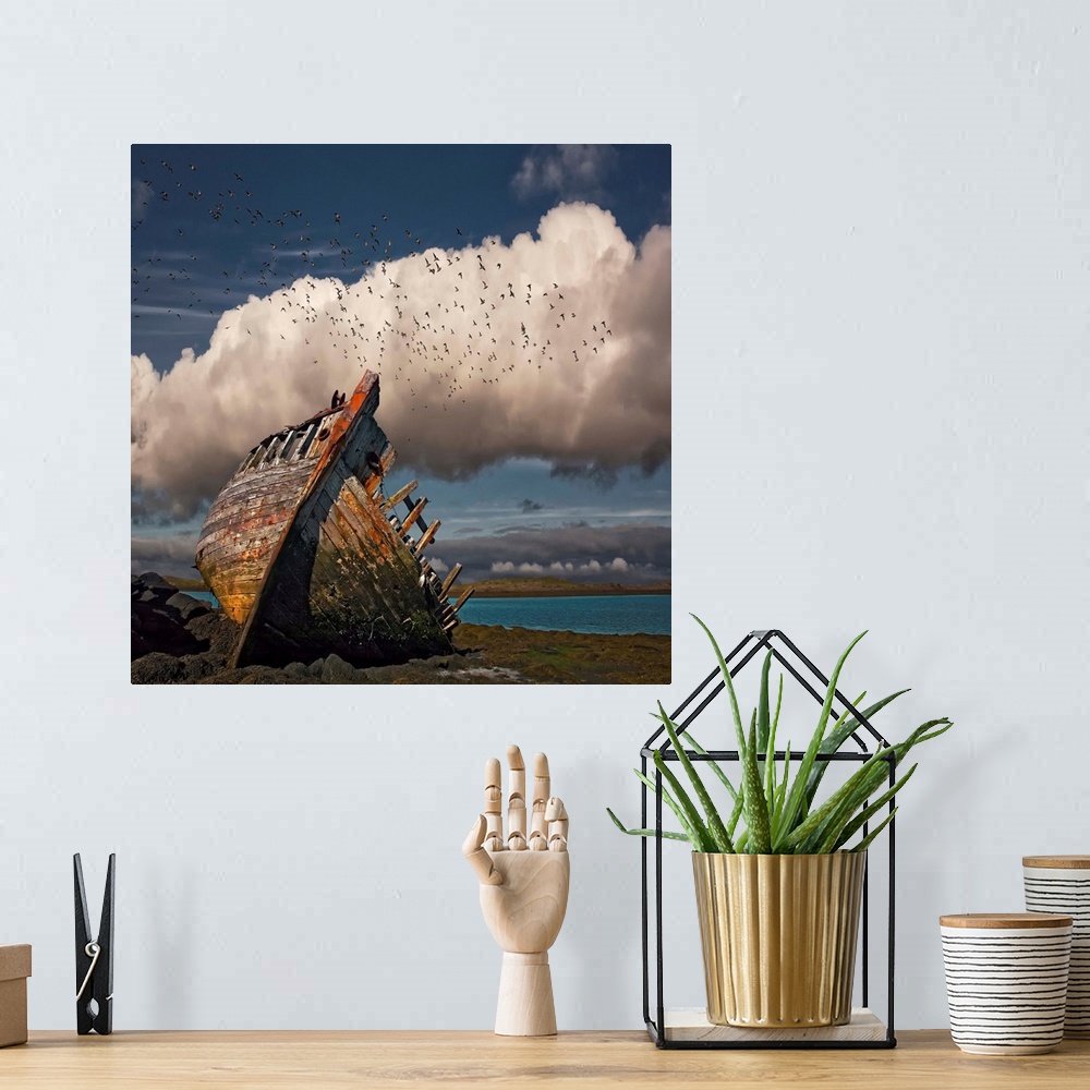 A bohemian room featuring A derelict boat on shore of an Icelandic beach.